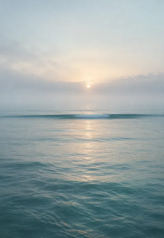 iPhone Duo ocean mist wallpaper for the cover screen, A calm ocean at dawn, soft fog over the water, a pale horizon, and a single distant wave line. 1398x2034 px