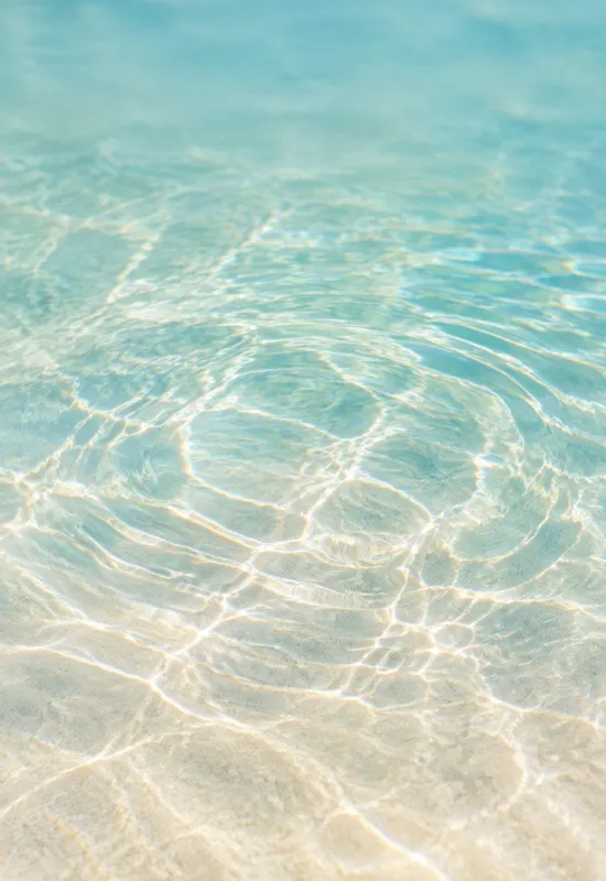 iPhone Duo sand ripples wallpaper for the cover screen, close-up shallow water ripples over pale sand, 1398x2034 px