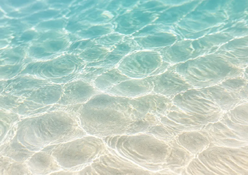 iPhone Duo sand ripples wallpaper for the inner display, a wide abstract pattern of shallow water ripples over pale sand, 2670x1878 px